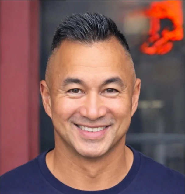 Chris Fischer, founder of NeighborlyPay, smiling outside a local storefront