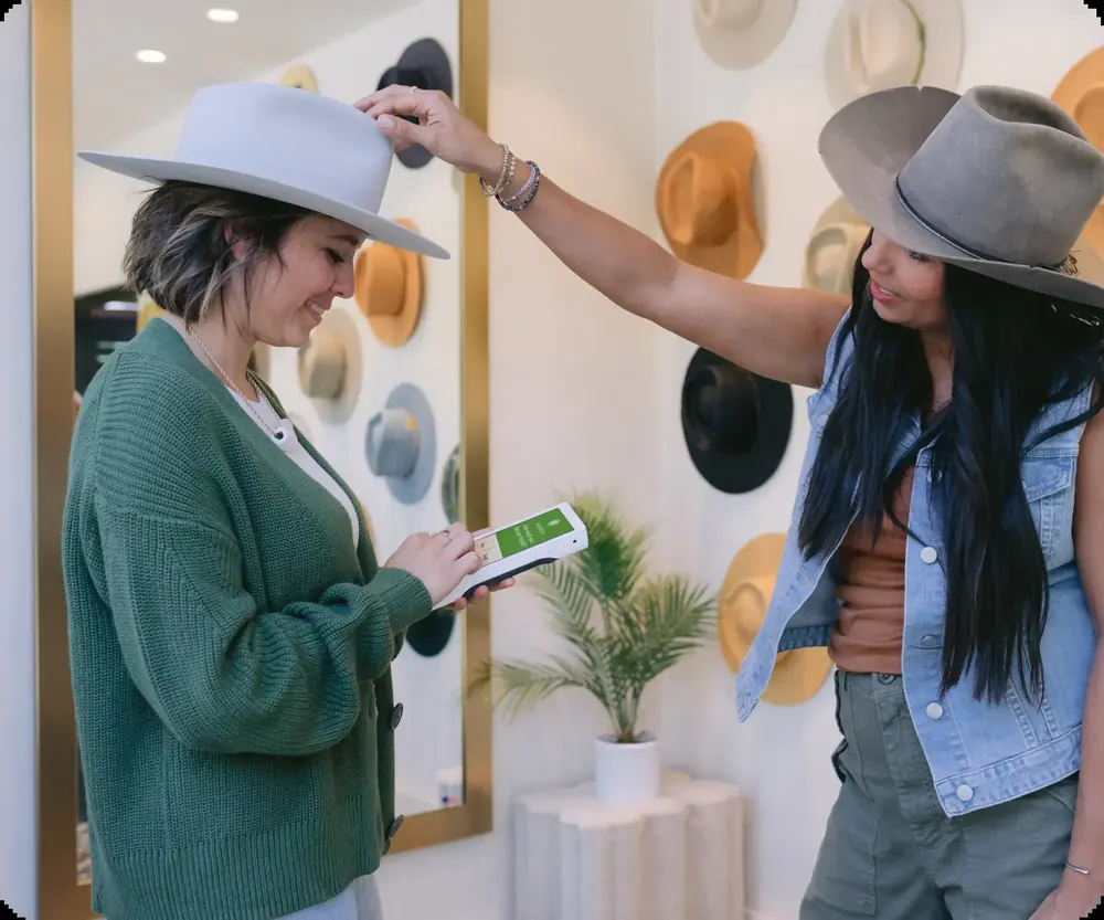 A boutique employee checking out a customer with a Clover Flex Pocket on the sales floor