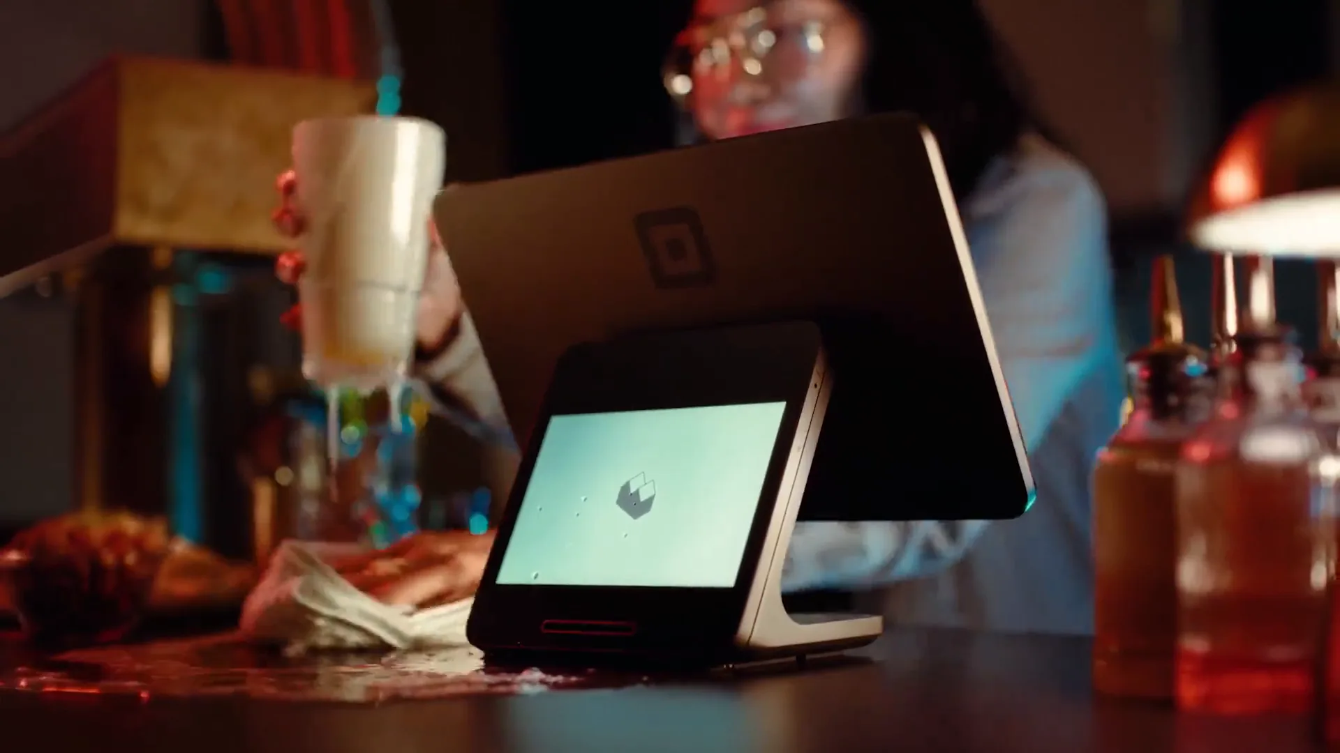 Square Register with its customer-facing screen on a busy bar counter