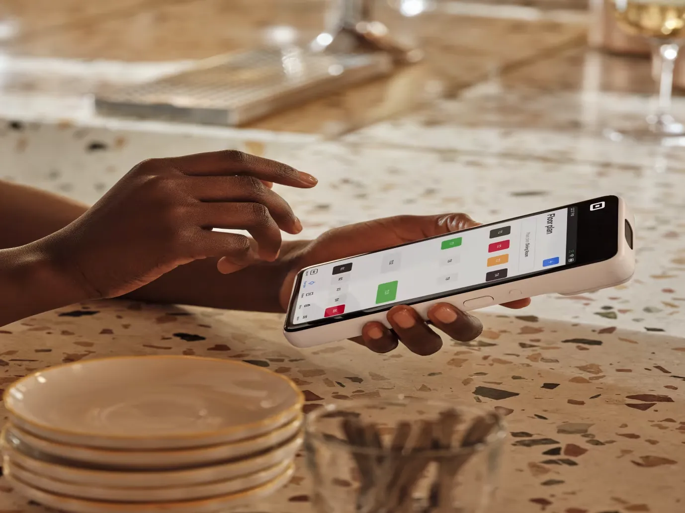 A server taking an order on Square Handheld at a restaurant table
